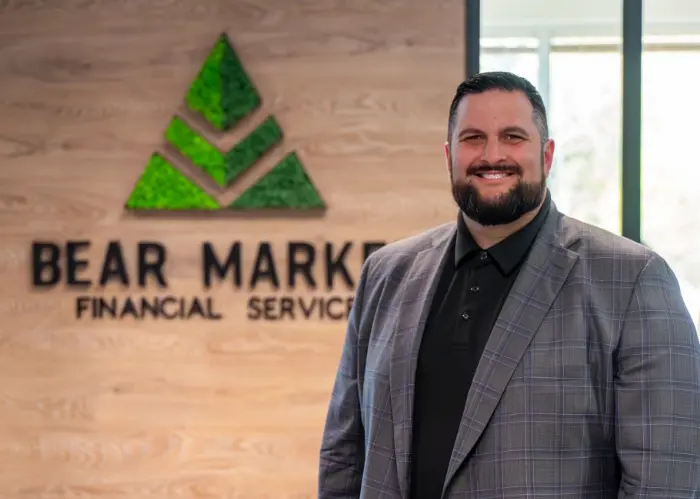 Curtis James standing next to Bear Market lobby logo